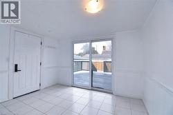 Sunroom featuring light tile patterned floors -