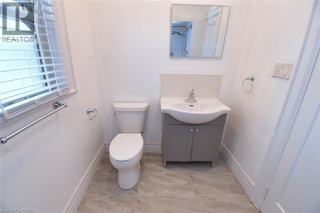 Bathroom featuring vanity and toilet - 215 Walter Avenue S, Hamilton, ON - Indoor Photo Showing Bathroom