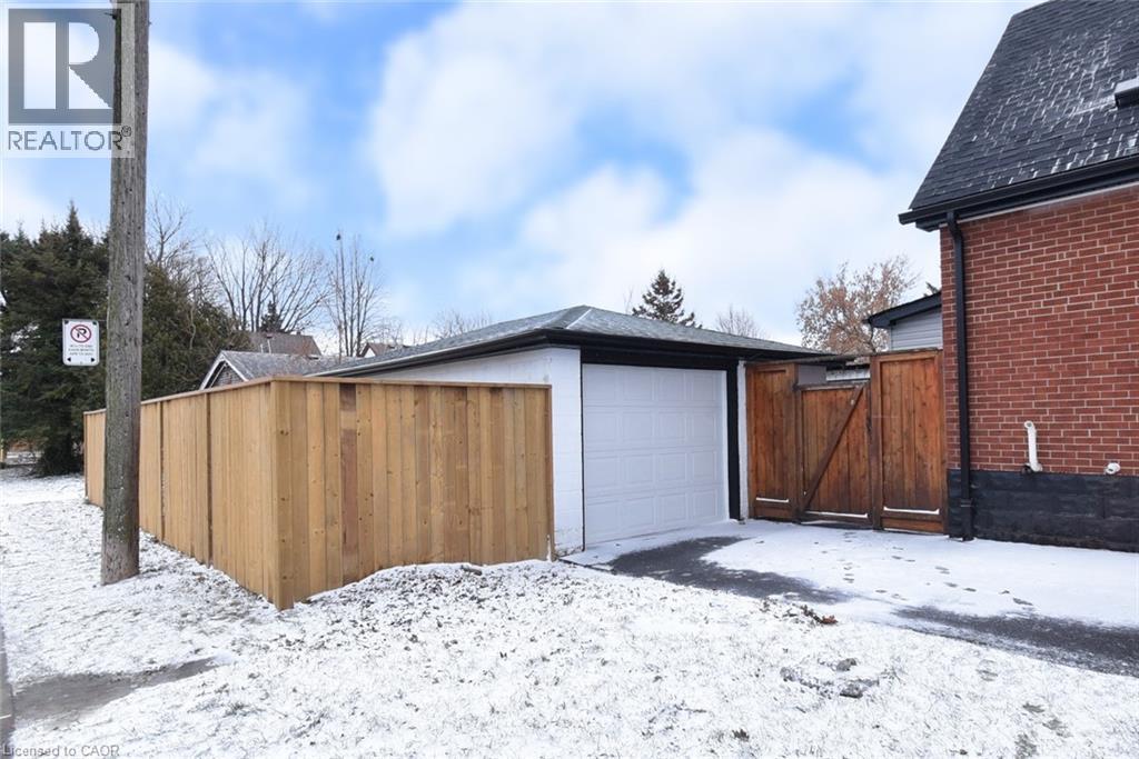 Snow covered garage featuring a gate - 215 Walter Avenue S, Hamilton, ON - Outdoor