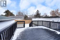 Wooden deck featuring a fenced backyard and a residential view -