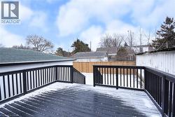 Wooden deck with a fenced backyard -