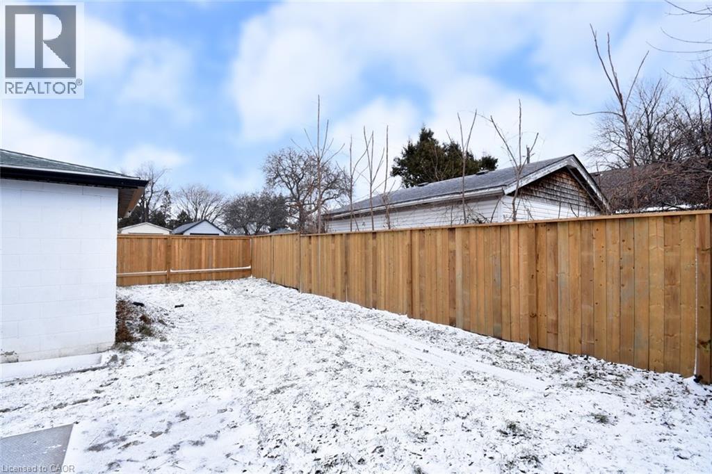 Snowy yard featuring a fenced backyard - 215 Walter Avenue S, Hamilton, ON - Outdoor
