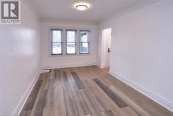 Empty room with light wood-type flooring and baseboards -