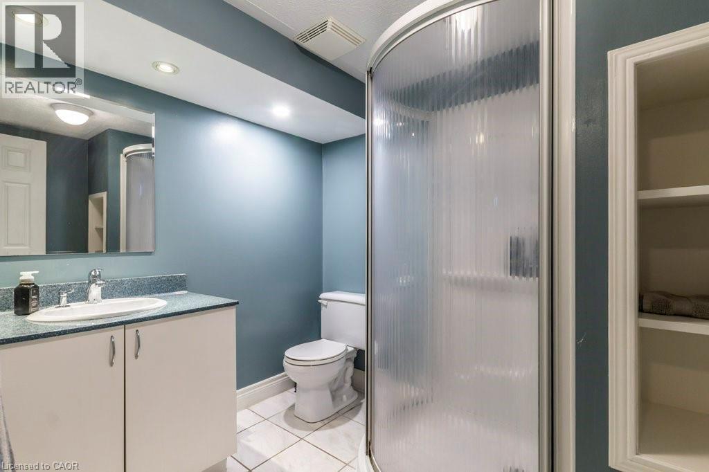 Bathroom featuring vanity, light tile patterned floors, a shower and recessed lighting - 22 Redwing Road, Hamilton, ON - Indoor Photo Showing Bathroom