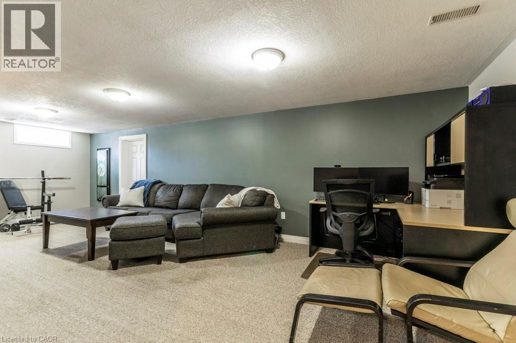 Large Rec Room/Living area with a textured ceiling, a desk, and light colored carpet - 22 Redwing Road, Hamilton, ON - Indoor