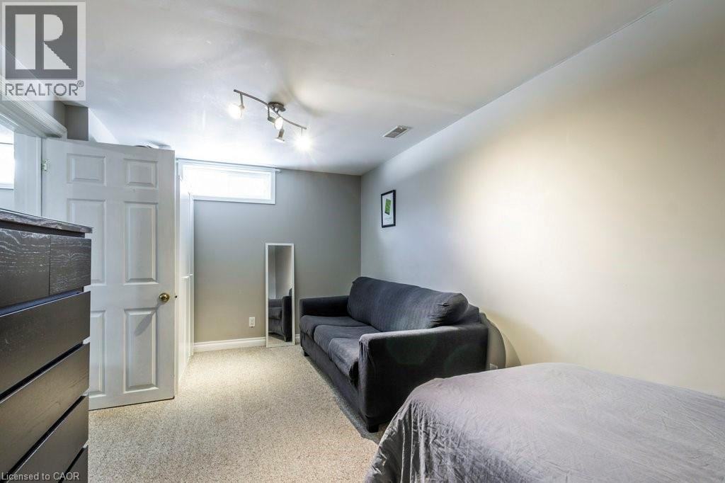 Bedroom with light carpet and rail lighting - 22 Redwing Road, Hamilton, ON - Indoor