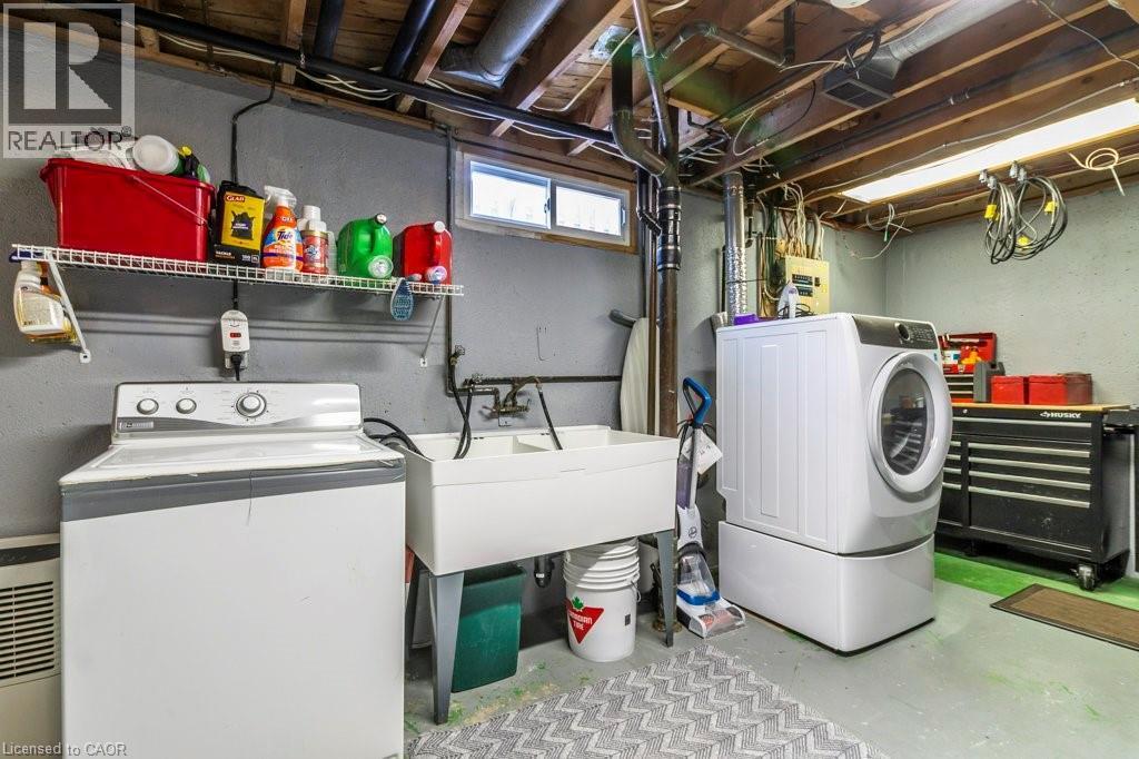 Washroom featuring unfinished concrete floors and separate washer and dryer - 22 Redwing Road, Hamilton, ON - Indoor Photo Showing Laundry Room