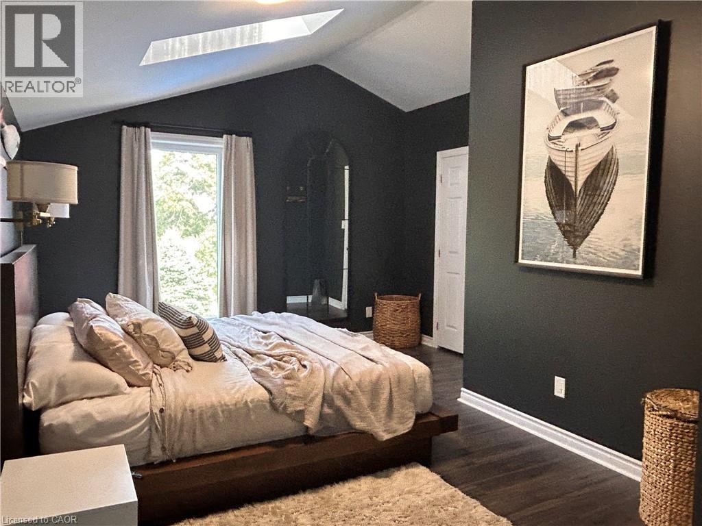 walk in closet, great view of back yard - 657 Windham Road 14, Simcoe, ON - Indoor Photo Showing Bedroom