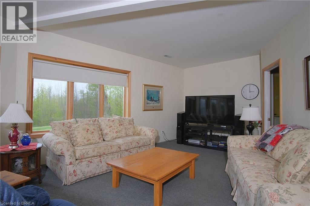 Large family room with wood fireplace. - 546299 Sideroad 4B, Kimberley, ON