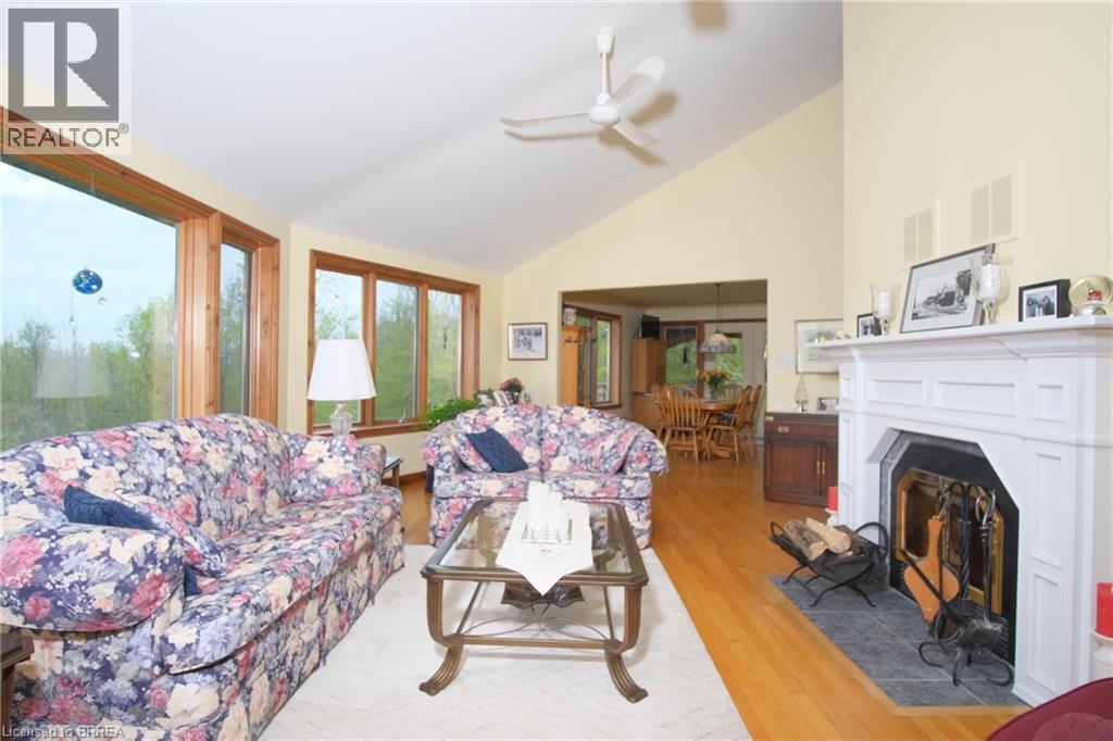 Large living room with wood fireplace. - 546299 Sideroad 4B, Kimberley, ON - Indoor Photo Showing Living Room With Fireplace