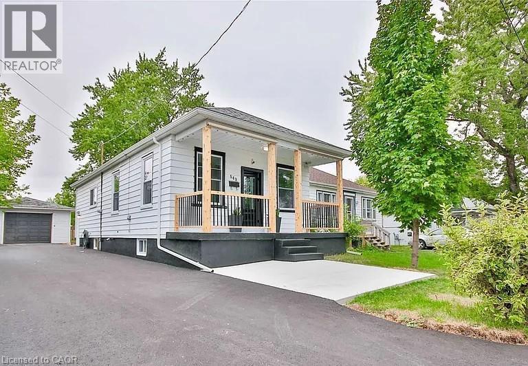 View of front of home featuring an outbuilding, covered porch, and a garage - 549 Waterloo Street, Hamilton, ON - Outdoor With Deck Patio Veranda