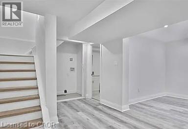 Finished basement featuring stairs and light wood-style floors - 549 Waterloo Street, Hamilton, ON - Indoor Photo Showing Other Room