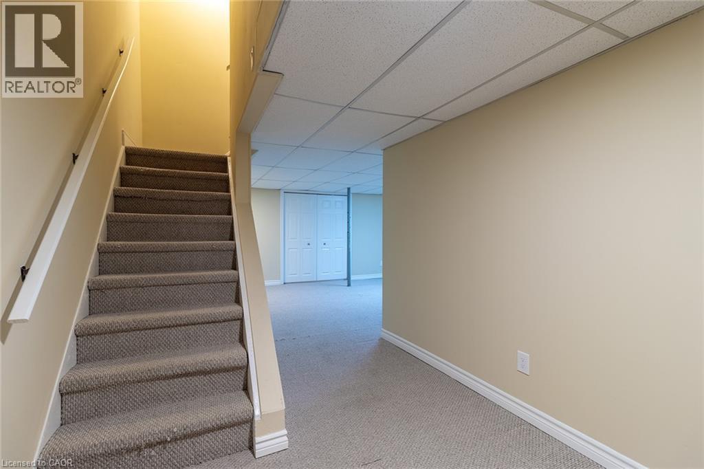 Stairs with a drop ceiling and carpet flooring - 58 Romy Crescent, Thorold, ON - Indoor Photo Showing Other Room
