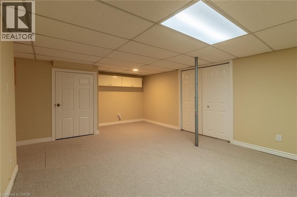Finished basement featuring a drop ceiling and light carpet - 58 Romy Crescent, Thorold, ON - Indoor