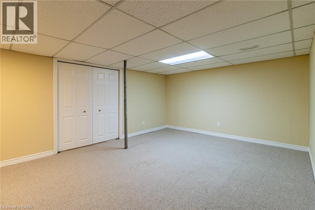 Finished below grade area with light colored carpet and a drop ceiling - 58 Romy Crescent, Thorold, ON - Indoor Photo Showing Basement