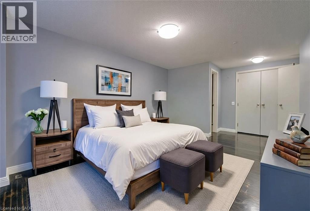 Bedroom featuring dark wood-style flooring, a textured ceiling, and a closet - 46 Guerin Avenue, Kitchener, ON - Indoor Photo Showing Bedroom