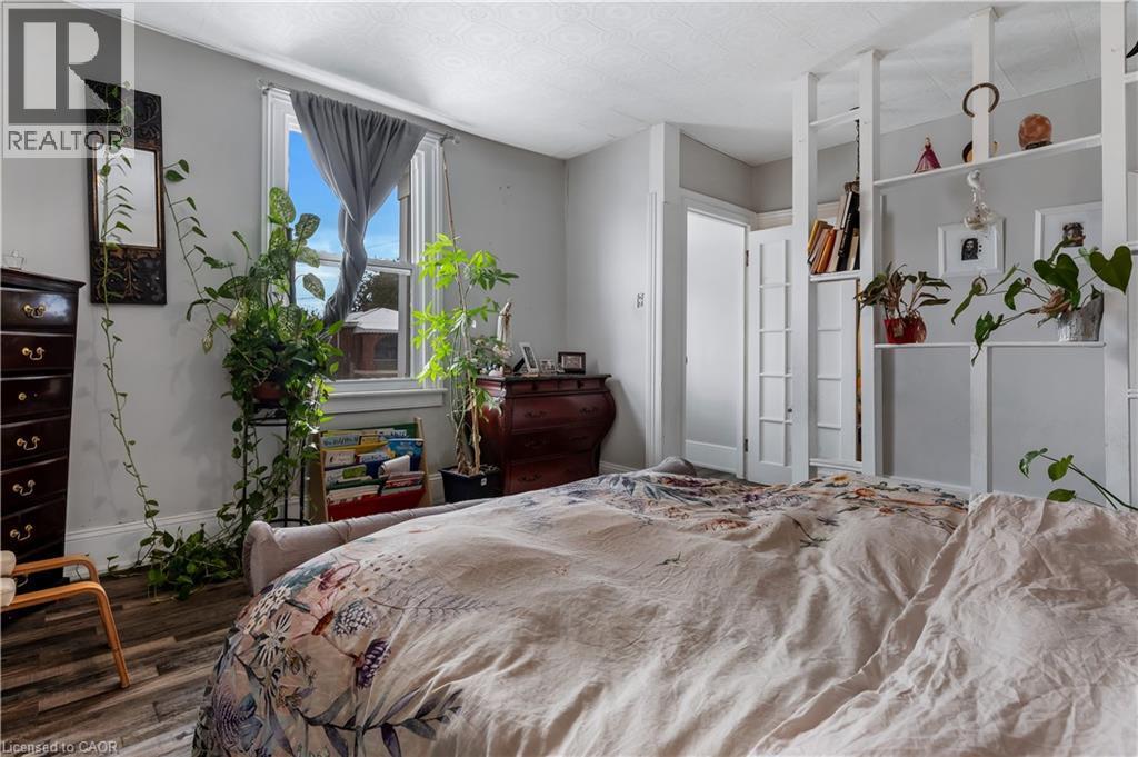 Bedroom with wood finished floors and baseboards - 193 Locke Street N, Hamilton, ON - Indoor Photo Showing Bedroom