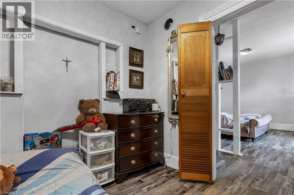 Bedroom featuring wood finished floors and baseboards - 193 Locke Street N, Hamilton, ON - Indoor Photo Showing Other Room