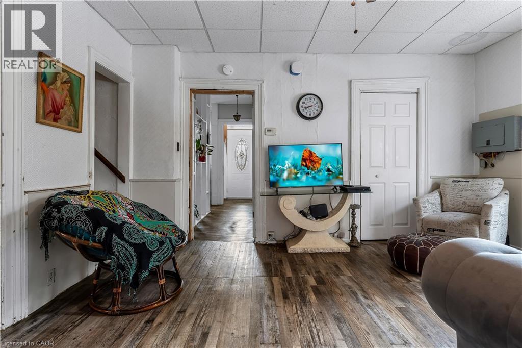 Living area with hardwood / wood-style floors and a paneled ceiling - 193 Locke Street N, Hamilton, ON - Indoor