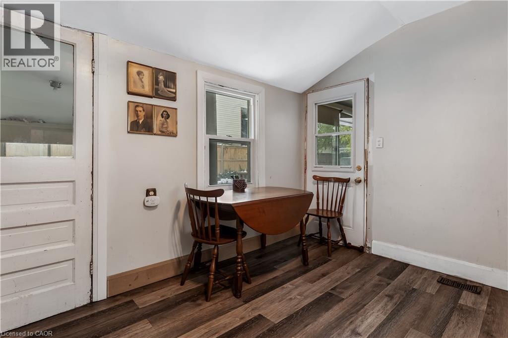 Dining room featuring vaulted ceiling and dark wood-type flooring - 193 Locke Street N, Hamilton, ON - Indoor Photo Showing Other Room