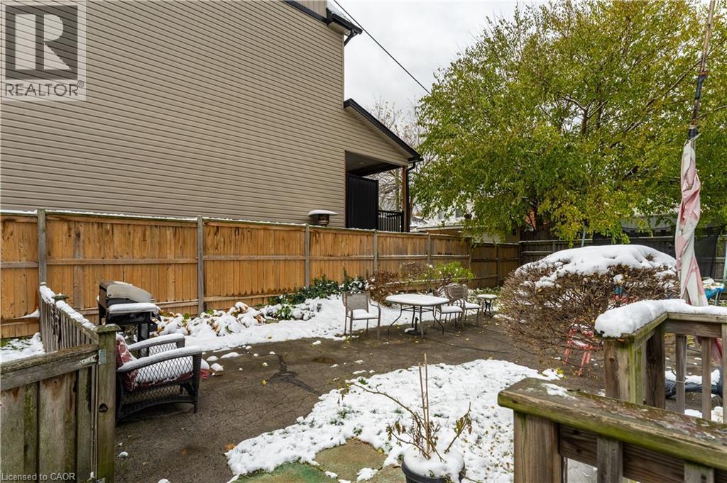 Fenced backyard featuring a patio area - 193 Locke Street N, Hamilton, ON - Outdoor