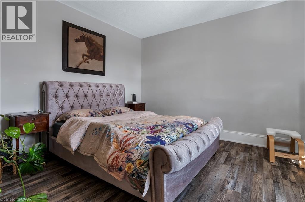 Bedroom featuring dark wood-type flooring - 193 Locke Street N, Hamilton, ON - Indoor Photo Showing Bedroom