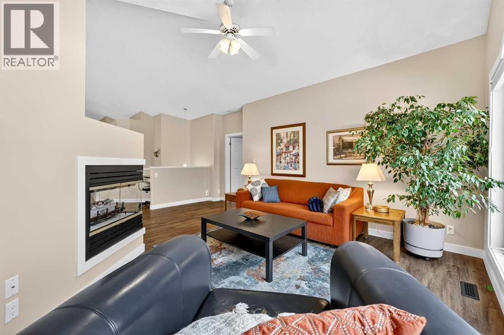 Living room receives lots of natural light - 509 Riverview Place Se, Calgary, AB - Indoor Photo Showing Living Room With Fireplace