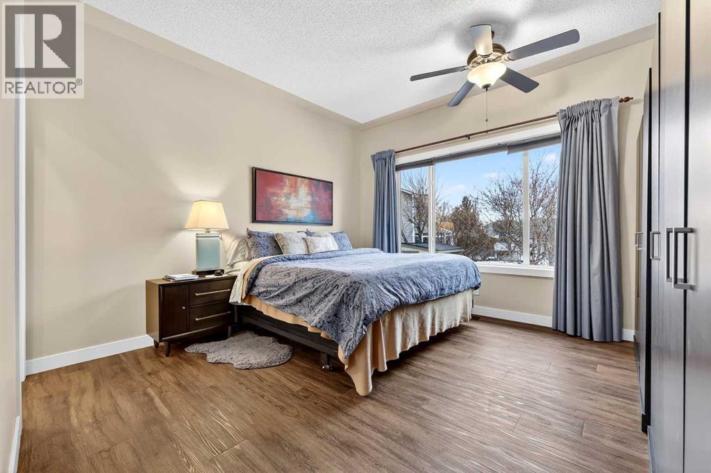 Primary bedroom has view to backyard and greenbelt to the west - 509 Riverview Place Se, Calgary, AB - Indoor Photo Showing Bedroom