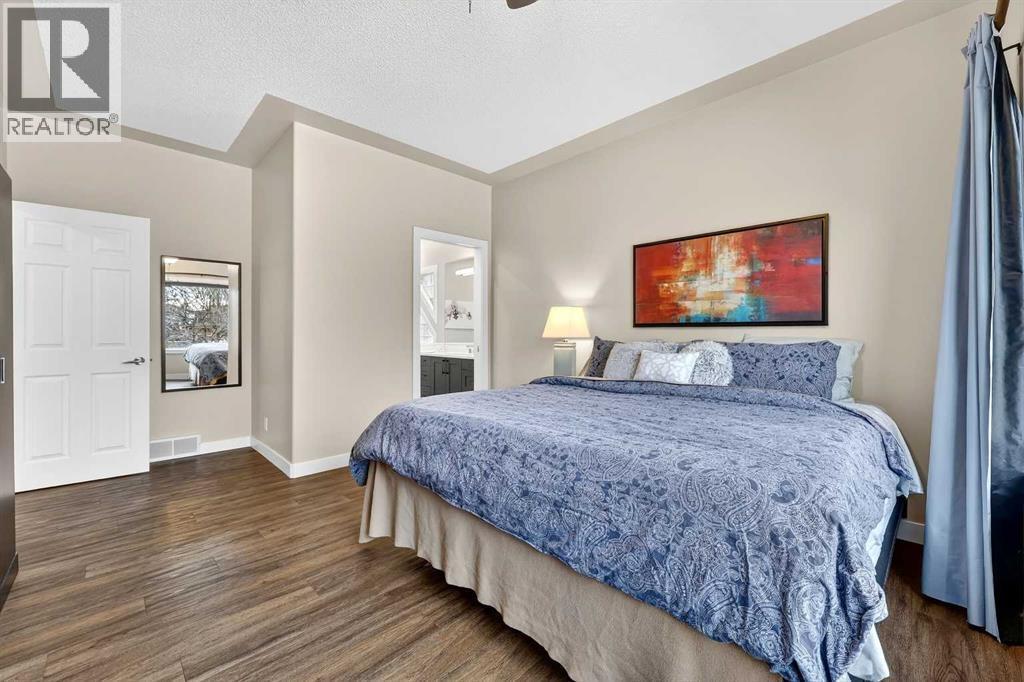 Primary bedroom is large enough for a king sized bed - 509 Riverview Place Se, Calgary, AB - Indoor Photo Showing Bedroom
