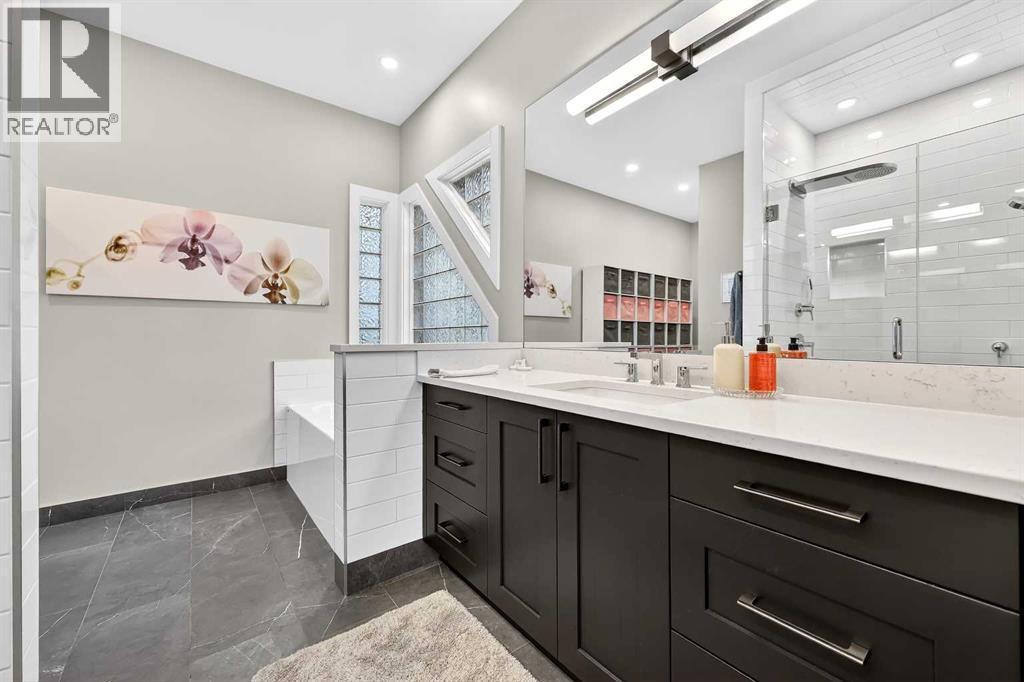 5-piece ensuite has been renovated with double sinks, walk-in shower, soaker tub - 509 Riverview Place Se, Calgary, AB - Indoor Photo Showing Bathroom