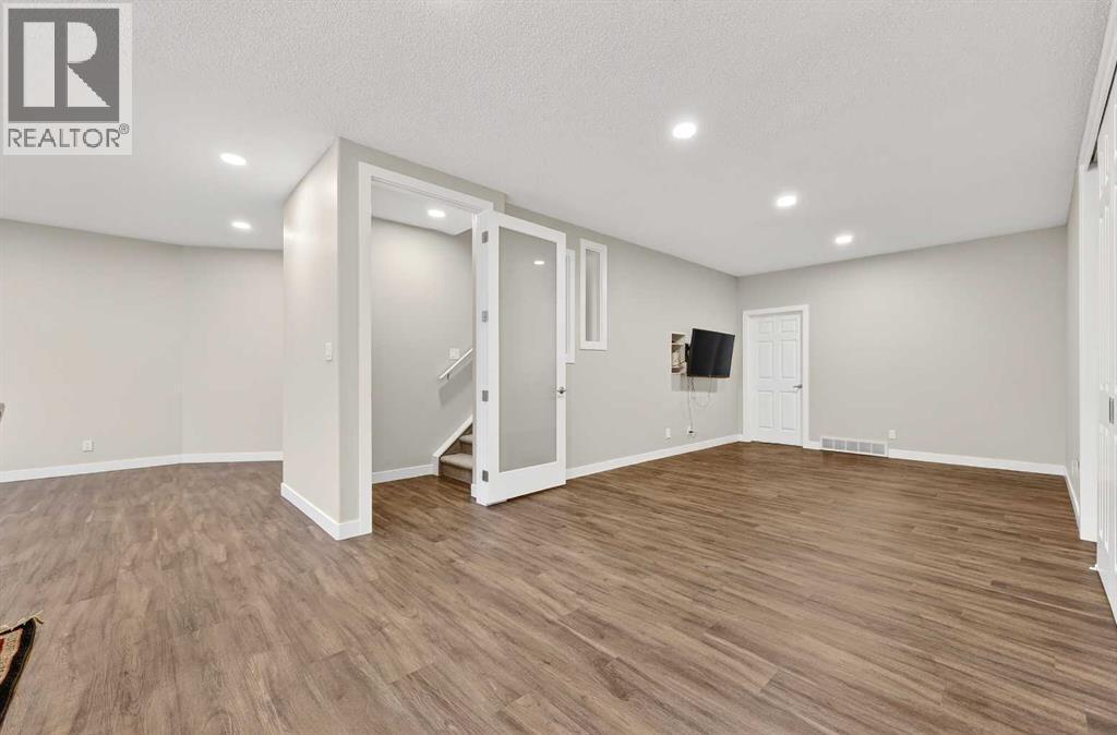 Basement has door at the bottom of the stairs in case privacy between the two living spaces is needed - 509 Riverview Place Se, Calgary, AB - Indoor