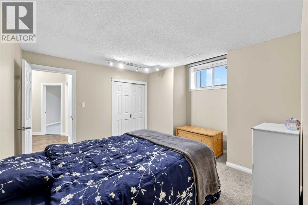 Spacious room also features cantilevered wall for additional visual interest and nook - 509 Riverview Place Se, Calgary, AB - Indoor Photo Showing Bedroom