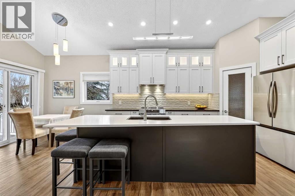 New kitchen with tall cabinets, large island, quartz counter tops and standalone pantry - 509 Riverview Place Se, Calgary, AB - Indoor Photo Showing Other Room