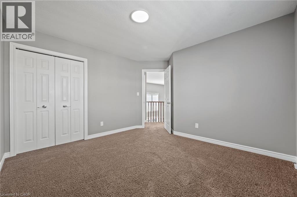 Unfurnished bedroom with a closet, baseboards, and carpet flooring - 561 Thomas Slee Drive, Kitchener, ON - Indoor Photo Showing Other Room