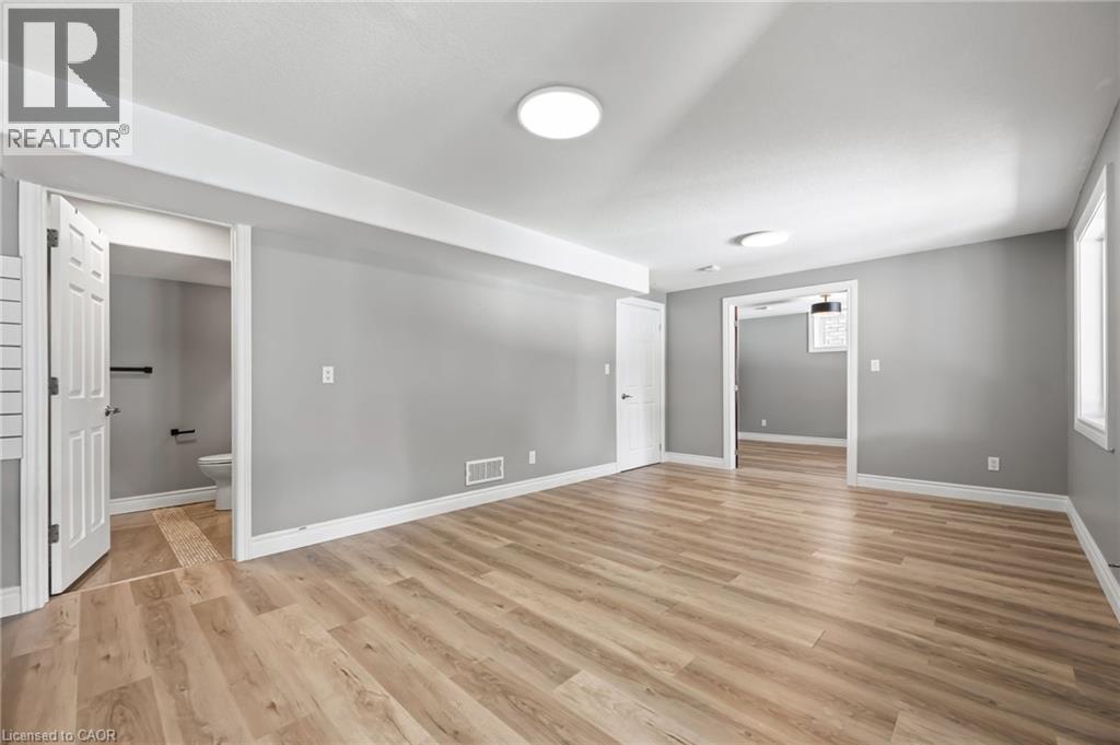 Unfurnished room featuring light wood finished floors, visible vents, and baseboards - 561 Thomas Slee Drive, Kitchener, ON - Indoor Photo Showing Other Room