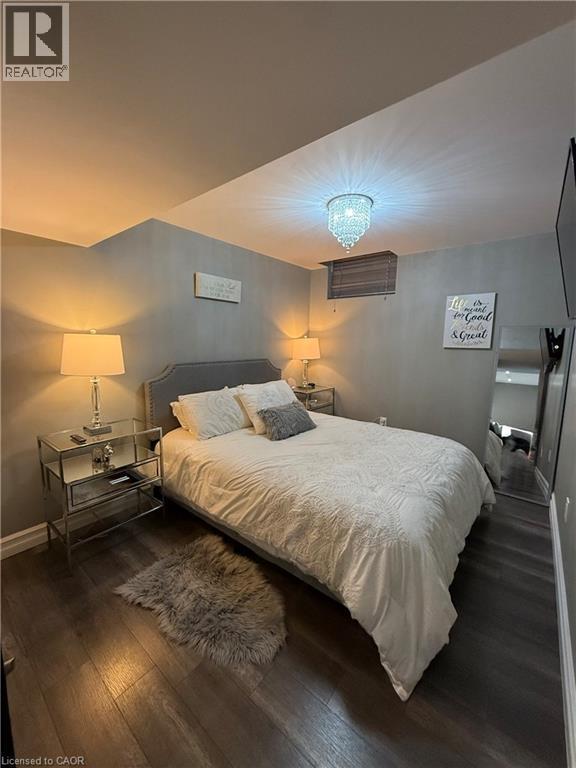 Bedroom featuring dark wood-type flooring and baseboards - 11 Donatello Court, Hamilton, ON - Indoor Photo Showing Bedroom