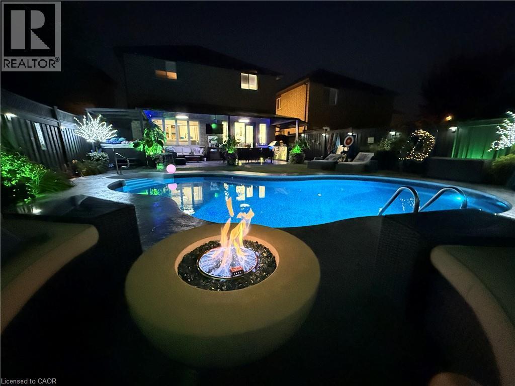 Swimming pool with a patio, a fire pit, and a fenced backyard - 11 Donatello Court, Hamilton, ON - Outdoor With In Ground Pool With Backyard