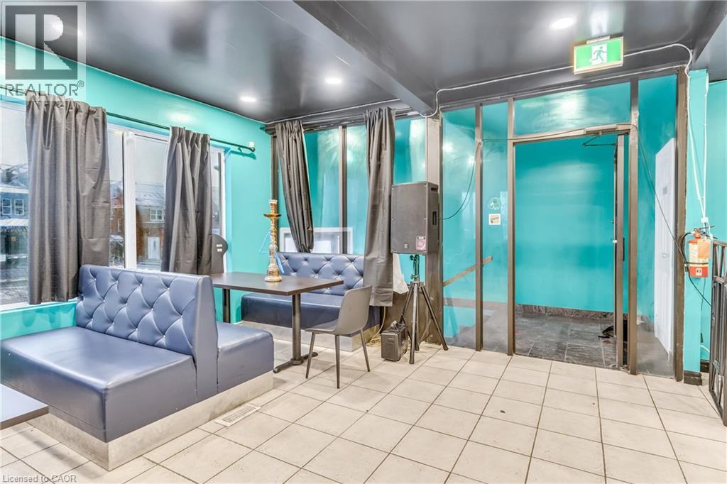 Dining room featuring tile patterned flooring and beam ceiling - 612 King Street E, Kitchener, ON