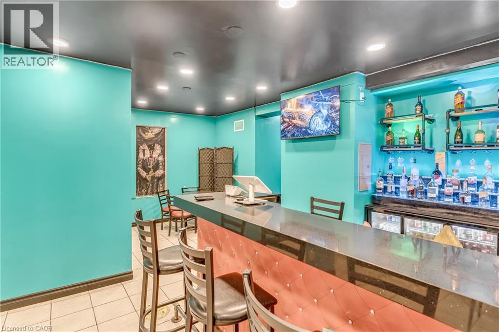Indoor dry bar featuring light tile patterned floors, recessed lighting, and electric panel - 612 King Street E, Kitchener, ON