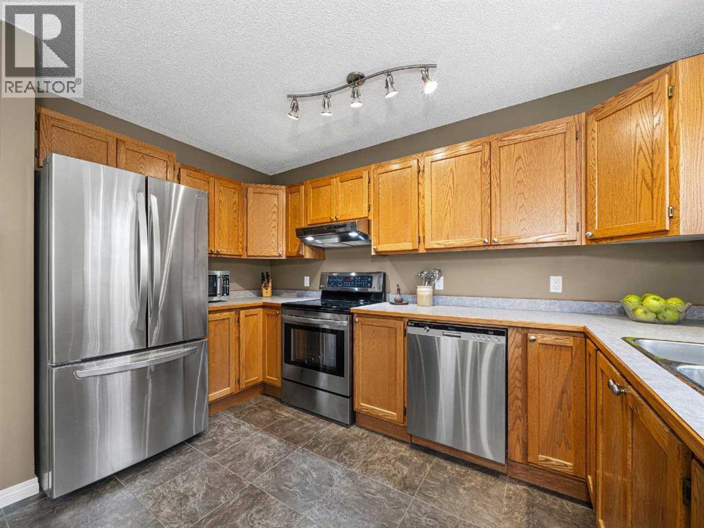 301 Arbour Cliff Close Nw, Calgary, AB - Indoor Photo Showing Kitchen With Stainless Steel Kitchen