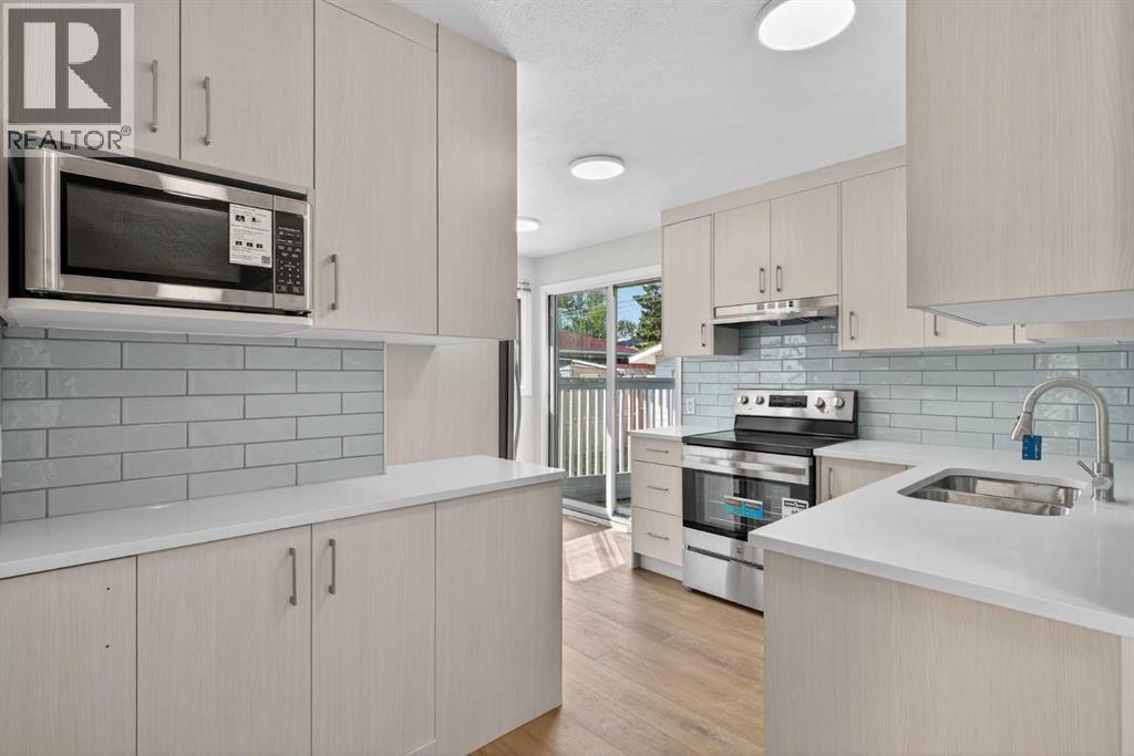 Mainfloor kitchen - 5923 Centre Street Nw, Calgary, AB - Indoor Photo Showing Kitchen With Double Sink With Upgraded Kitchen