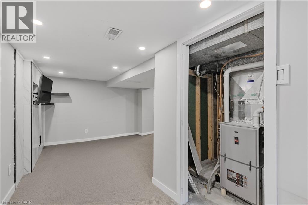 Finished below grade area featuring recessed lighting, heating unit, and light carpet - 191 East 11Th Street, Hamilton, ON - Indoor
