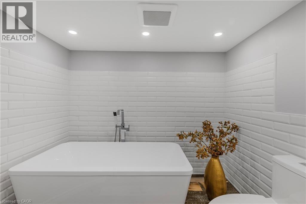 Bathroom featuring a freestanding bath and recessed lighting - 191 East 11Th Street, Hamilton, ON - Indoor Photo Showing Bathroom