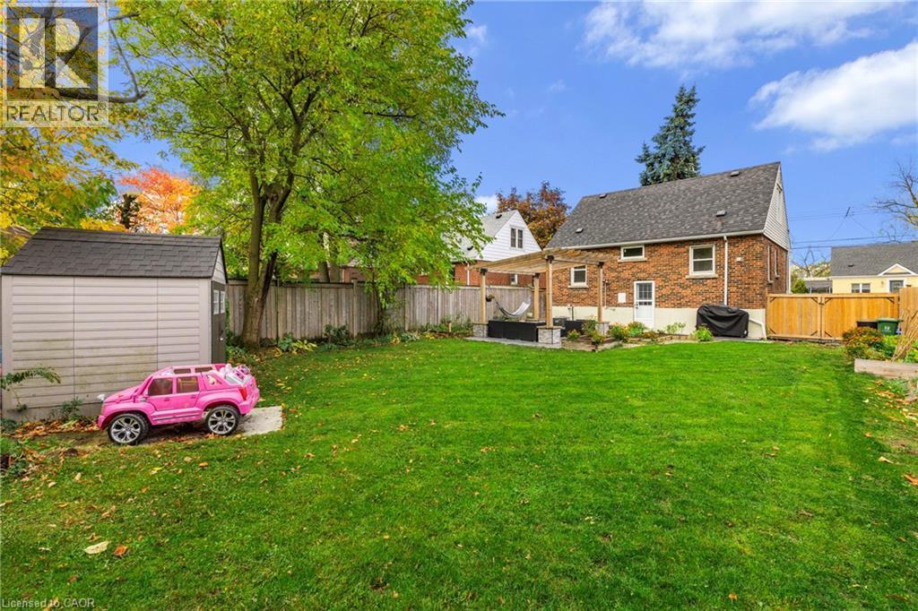 Fenced backyard with a shed and a patio - 191 East 11Th Street, Hamilton, ON - Outdoor