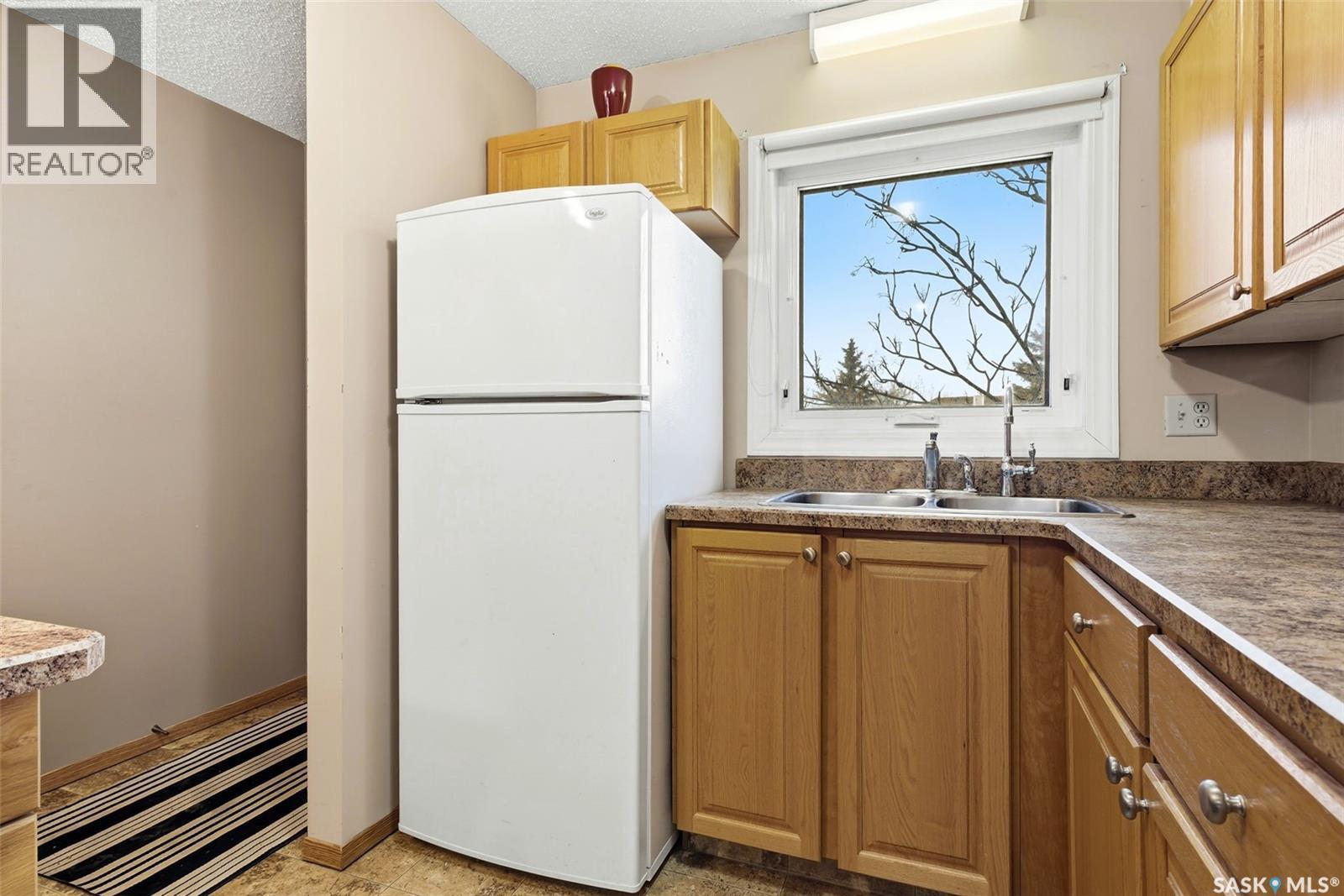 114 Cedar Meadow Drive, Regina, SK - Indoor Photo Showing Kitchen With Double Sink