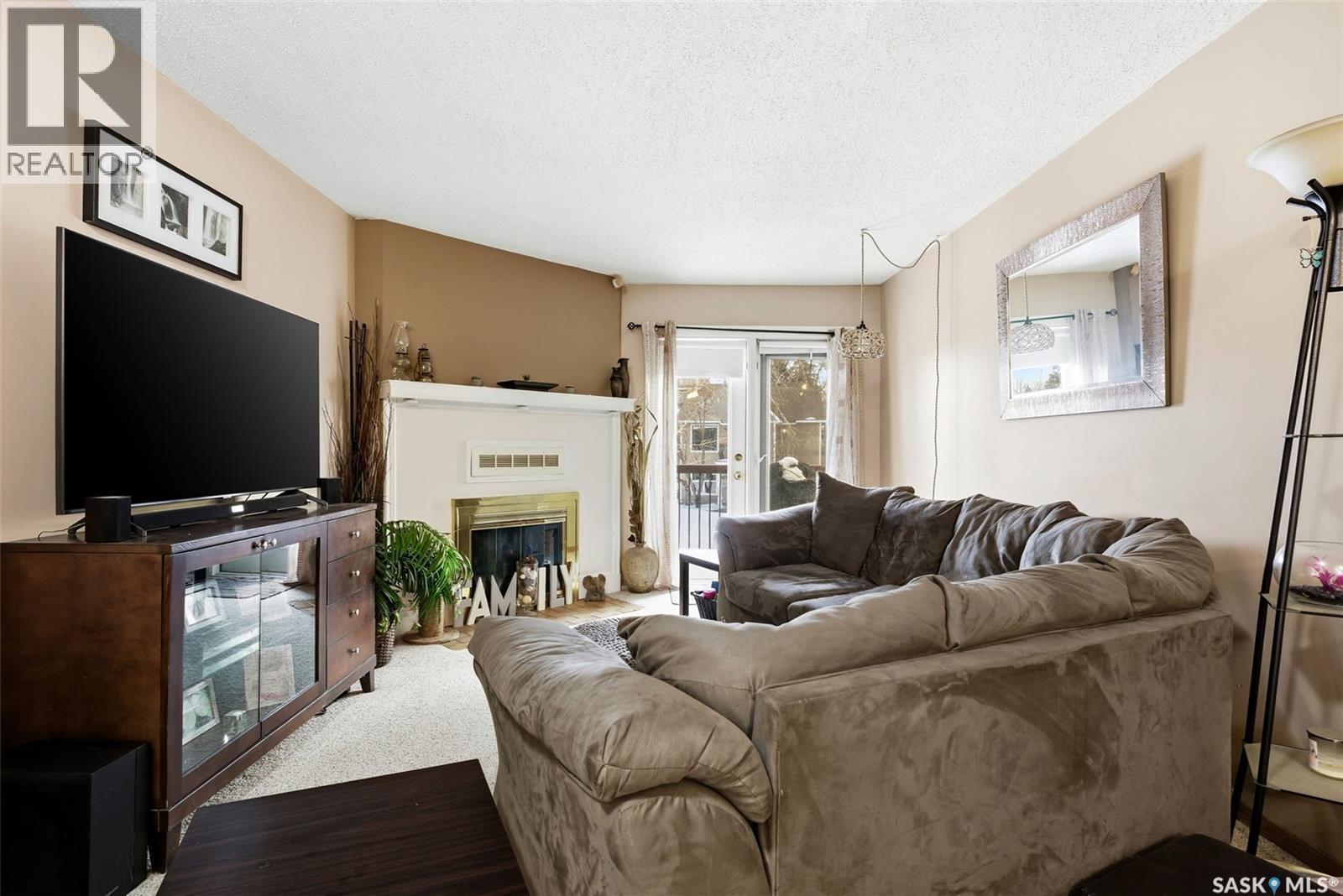 114 Cedar Meadow Drive, Regina, SK - Indoor Photo Showing Living Room With Fireplace