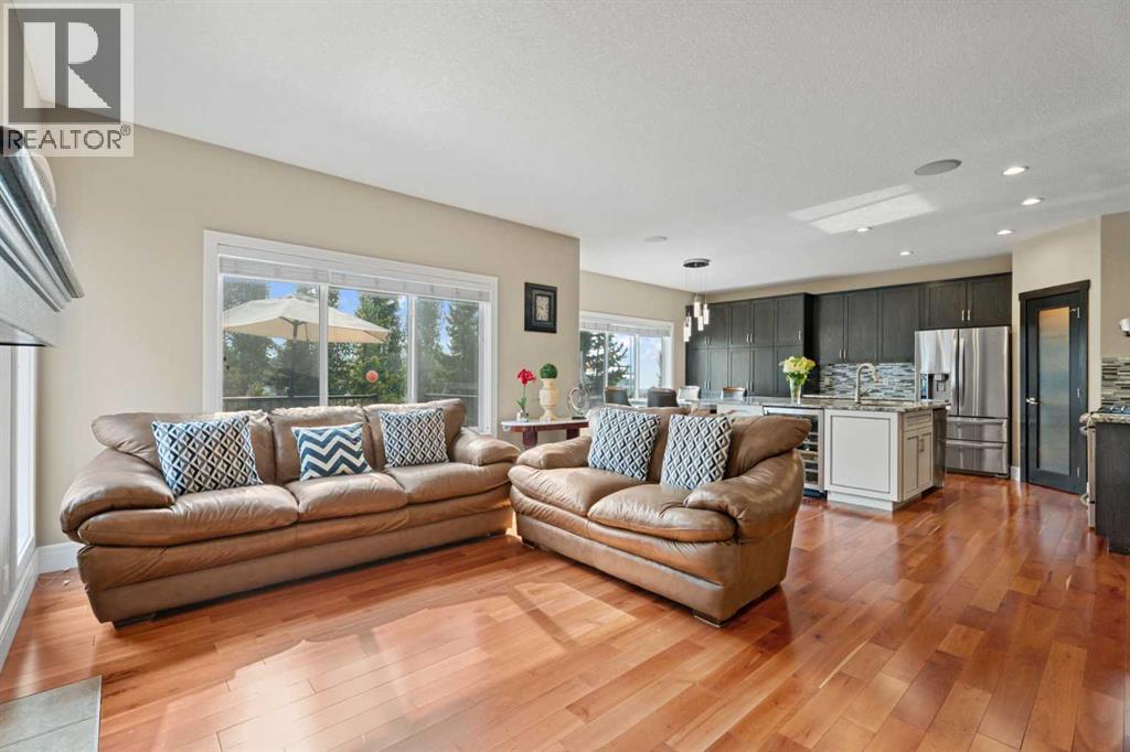 The living room/dining room/kitchen are nicely separated from the office - 113 Aspen Stone Place Sw, Calgary, AB - Indoor Photo Showing Living Room