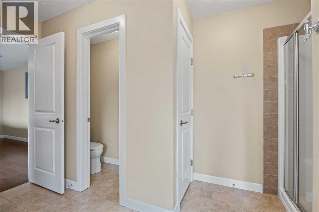 The toilet has its own private room - 113 Aspen Stone Place Sw, Calgary, AB - Indoor