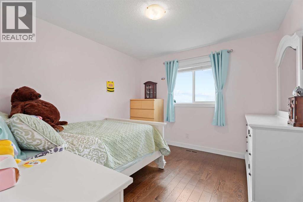 Bedroom 2 with mountain views out the window - 113 Aspen Stone Place Sw, Calgary, AB - Indoor Photo Showing Bedroom