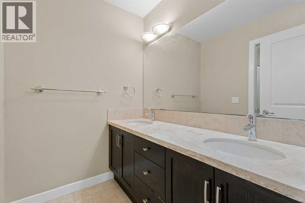The sinks are separate from the tub & toilet making it useful for more than one person at a time - 113 Aspen Stone Place Sw, Calgary, AB - Indoor Photo Showing Bathroom